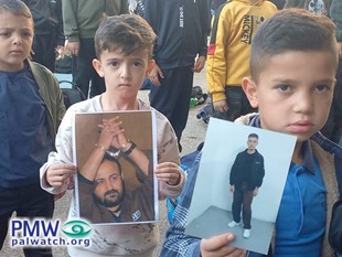 Kids holding poster of terrorist